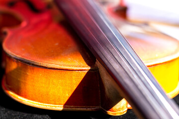 Fragment of handmade violin. Selective focus. Topic: bowed musical instruments, background for poster of violin music concert, advertising background of musical goods