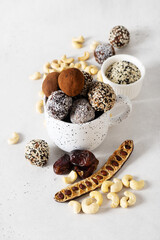 Carob energy balls with nuts, dates and coconut, vegan and vegetarian sweet food
