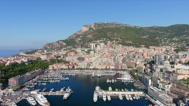 Monte Carlo, Monaco. Aerial view of famous city towering over Mediterranean Sea, yachts and boats in marina Port Hercules in La Condamine - landscape panorama of Europe from above
