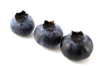 Three blueberries isolated on white background.