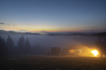 Foggy morning, rural house in the Carpathians, beautiful landscape