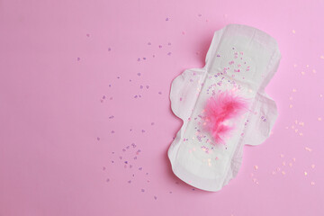 Menstrual pad and confetti on pink background, top view. Space for text