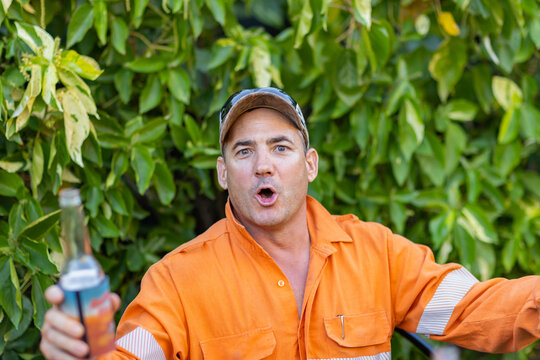 bloke in hi-vis workwear with stubby in hand
