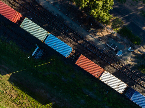 Aerial view of containers on a freight train in small Aussie town
