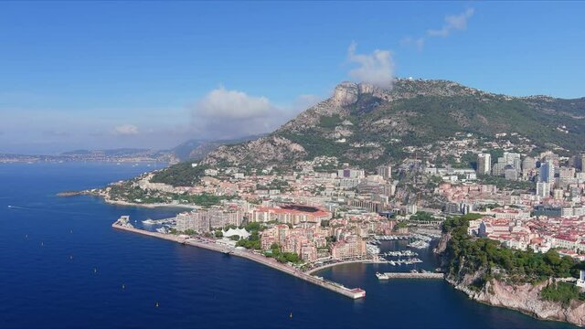 Monte Carlo, Monaco. Aerial view of famous city towering over Mediterranean Sea, ships and boats in yachting marina Port de Fontvieille - landscape panorama of Europe from above