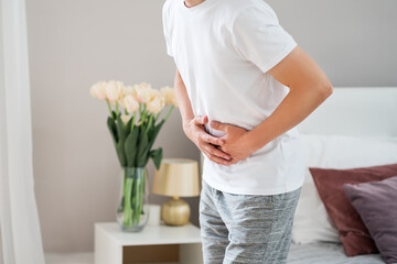 Man with abdominal pain suffering at home