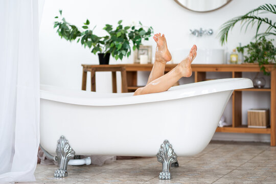 Woman Relaxing In Bathroom, Slim Legs With Smooth Skin, Foot Care Concept