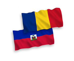 National vector fabric wave flags of Romania and Republic of Haiti isolated on white background. 1 to 2 proportion.