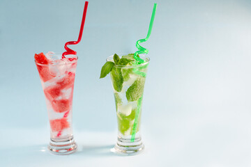 Refreshing summer drinks. Fresh drinks with ice. Cold lemonades: watermelon lemonade and mint are the best to quench your thirst in the summer heat. Blue background. Close-up. Copy space.