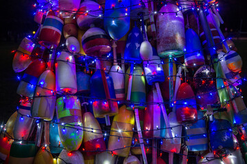 weathered fishing buoys with Christmas lights. beautiful holiday background