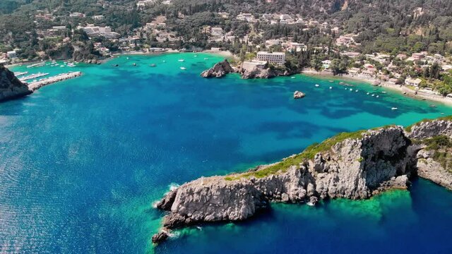 Aerial view of turquoise bay in resort village of Paleokastritsa. Drone shot.