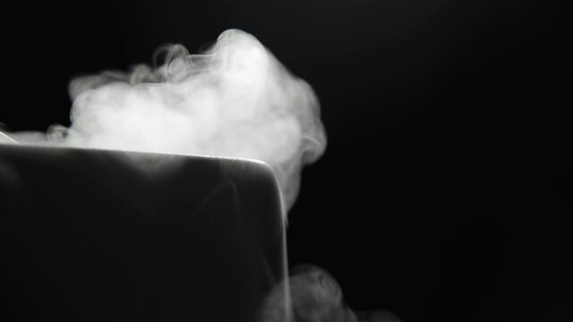 Elegant humidifier on a black background. Thick clouds of steam radiate from him. Optimum humidity and fresh, clean air. Close-up