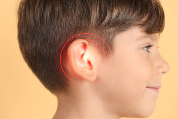 Little boy on color background, closeup. Hearing problem