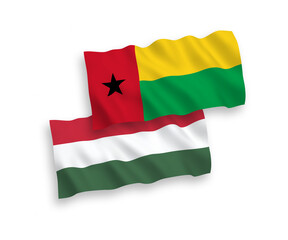 National vector fabric wave flags of Republic of Guinea Bissau and Hungary isolated on white background. 1 to 2 proportion.