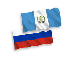National vector fabric wave flags of Republic of Guatemala and Russia isolated on white background. 1 to 2 proportion.