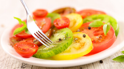 colorful fresh tomato salad with basil