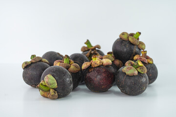 Ripe mangosteen or locally known as manggis, a famous fruit in Malaysia, regarded as the queen of fruits. Selective focus points. Blurred background 