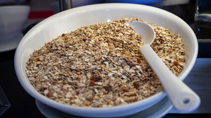 Oatmeal, muesli on white plate, healthy diet food concept, vegetarianism