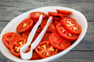 tomato. slices of tomato are on a white plate. Healthy diet food concept, vegetarianism