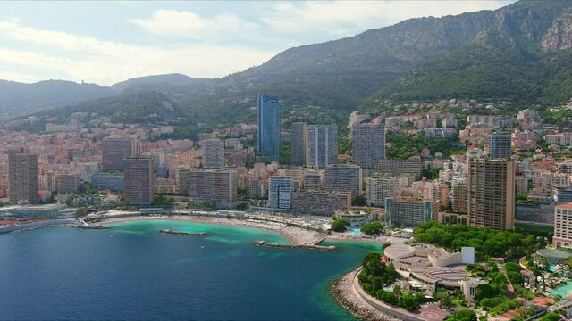 Monte Carlo, Monaco. Aerial view of famous city towering over Mediterranean Sea, modern high-rise buildings, Les Plages beaches  - landscape panorama of Europe from above