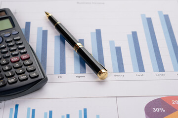 Obraz premium Accounting business concept. Close-up calculator with pen at financial report background.