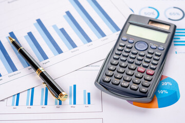 Accounting business concept. Close-up calculator with pen at financial report background.