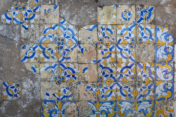antique damaged wall with blue and yellow Portuguese azulejos (tiles)