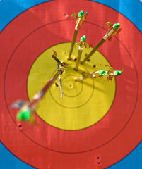Archery - Targetface with arrows. On arrow hit another one, cracked the shaft and stuck in the...