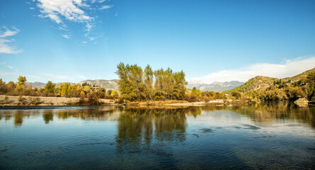 Fototapeta premium The turquoise waters of Köprüçay, a rafting center, and the yellow of autumn around it