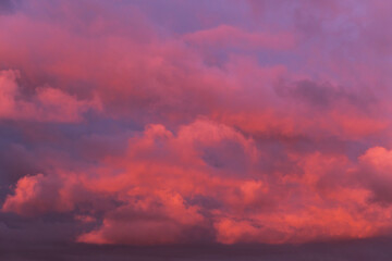 Fototapeta na wymiar Epic Dramatic sunrise, sunset orange pink red clouds in sunlight on storm sky background texture