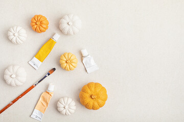 Hobby background with handmade gypsum pumpkins, paint brushes and art accessories
