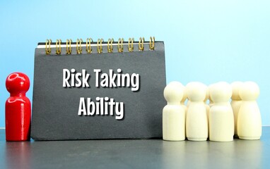 peg doll, a notebook with the words risk taking ability