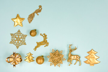 Fototapeta na wymiar Flat christmas card with new year toys, snowflakes, balls, deer, fir tree, peacock and gift box on blue background. Place for an inscription.