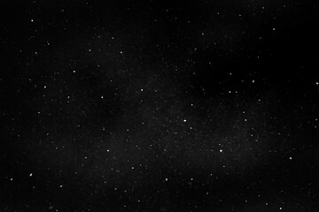 Fototapeta na wymiar Flying snow on black background. Snow overlay texture. High quality photo