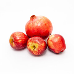 Pomegranate and apples on white background