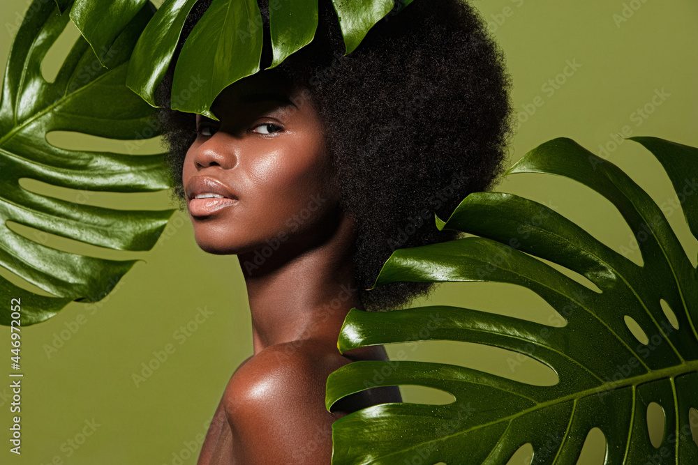 Wall mural green beauty portrait of young beautiful african american woman with posing against green exotixc pl