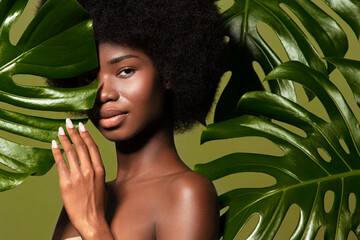 Connected with a nature. Beauty portrait of young beautiful african american woman with posing...