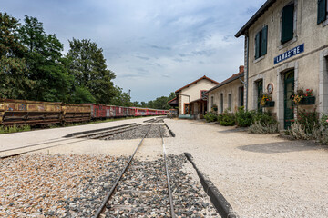 Fototapeta na wymiar Old Lamastre train station with an antic freight train on the background at french Ardèche region.