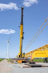Fototapeta na wymiar Dutch construction site new wind turbine farm with big crane