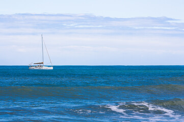 Fototapeta premium Sailing boat stays close to shore on a calm day.Copy space