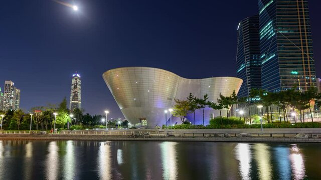 Architecture Tri-bowl with skyscraper building and songdo river in central park at night