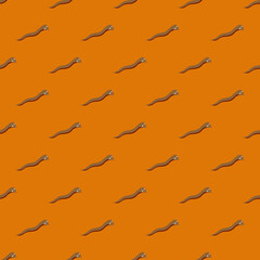 Brown small worms silhouettes seamless doodle pattern in minimalistic style. Orange bright background.