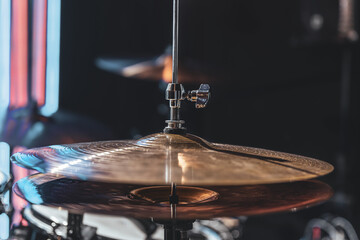 Close-up of a drum cymbal on a blurred background.