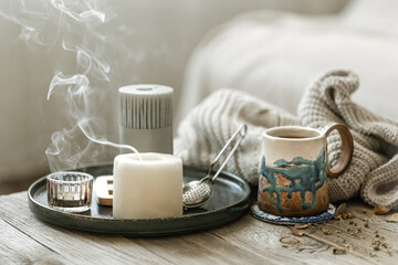 Home scandinavian style still life with a cup of tea and candles.