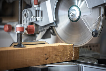 Close-up of a miter saw in a carpenter's workshop.