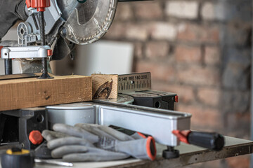 Close-up of a miter saw in a carpenter's workshop.