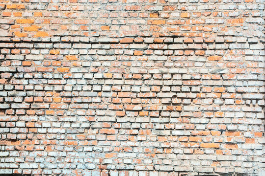 large old weathered red brick wall with cement