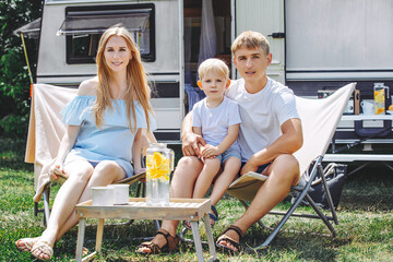 Family mother, father and son are beautiful and happy together, traveling in a trailer, a mobile...