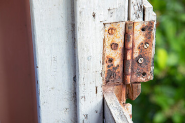 A rusted out butt hinge on the top half of a dutch door