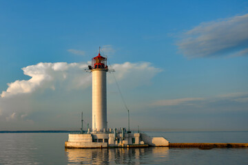 Red-white lighthouse in the seaport shipping company.